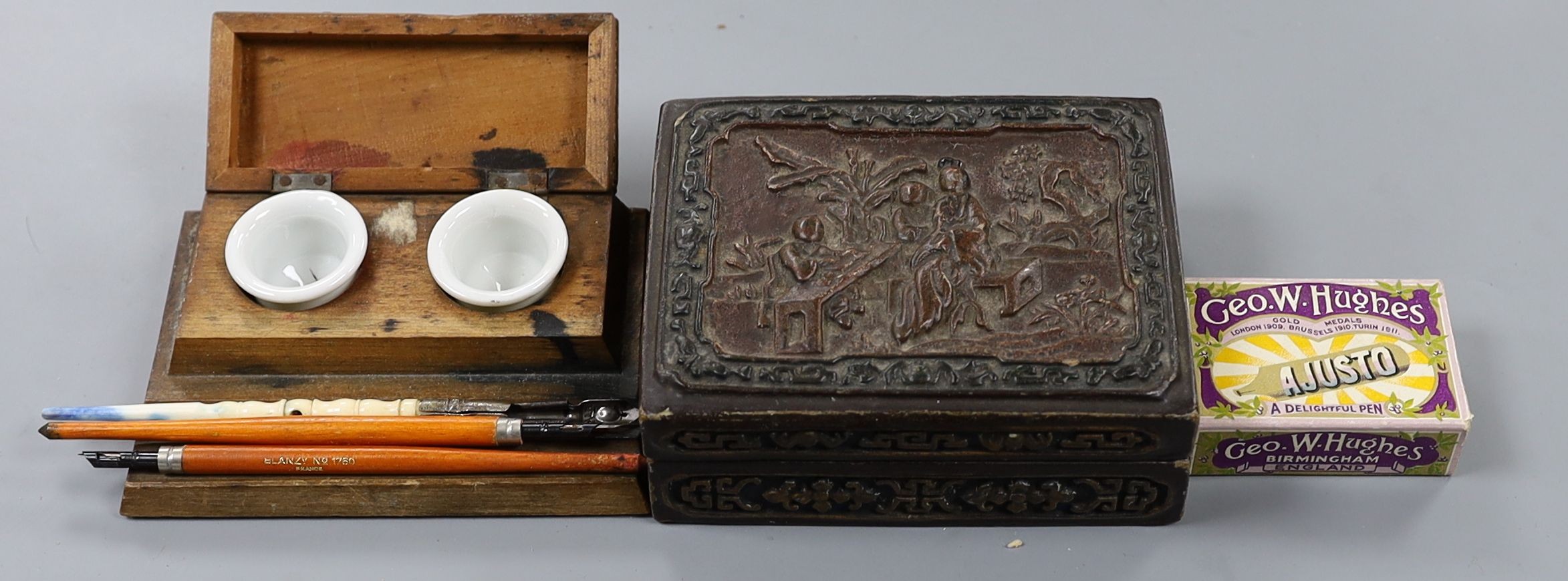 A Chinese rectangular lacquered composition box, an inkstand, three knib-pens and knibs